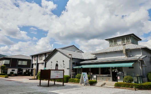 宮崎県綾町の「グラスアート黒木」。日本のガラス工芸の工房としては最大規模で、事務系スタッフを含め約50人の社員を擁する。緑の日よけがある工房の窓から、制作の様子を見学できる。