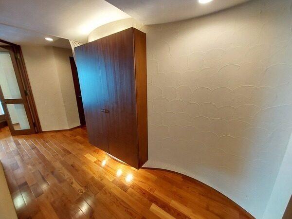 玄関から居室へ向かう廊下の様子。間接照明が施されており、柔らかな光がお住まいの方やゲストを迎えます。