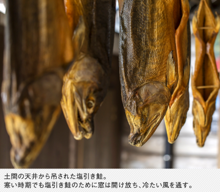 土間の天井から吊された塩引き鮭。寒い時期でも塩引き鮭のために窓は開け放ち、冷たい風を通す。