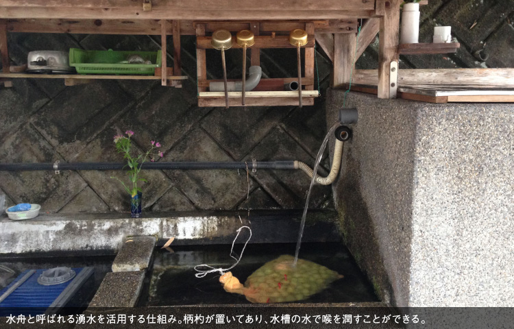 水舟と呼ばれる湧水を活用する仕組み。柄杓が置いてあり、水槽の水で喉を潤すことができる。